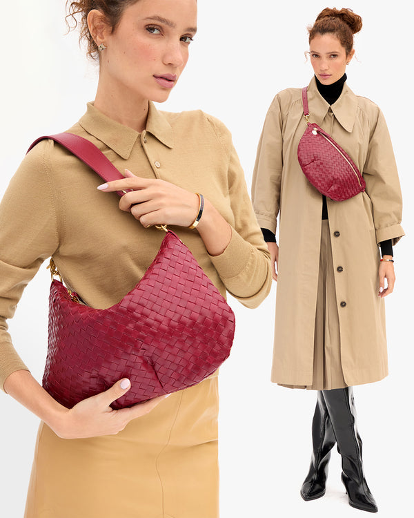 Model carrying the Garnet Diagonal Woven Moyen Messenger as a shoulder bag and Garnet Diagonal Woven Grande Fanny that sits across her chest. 