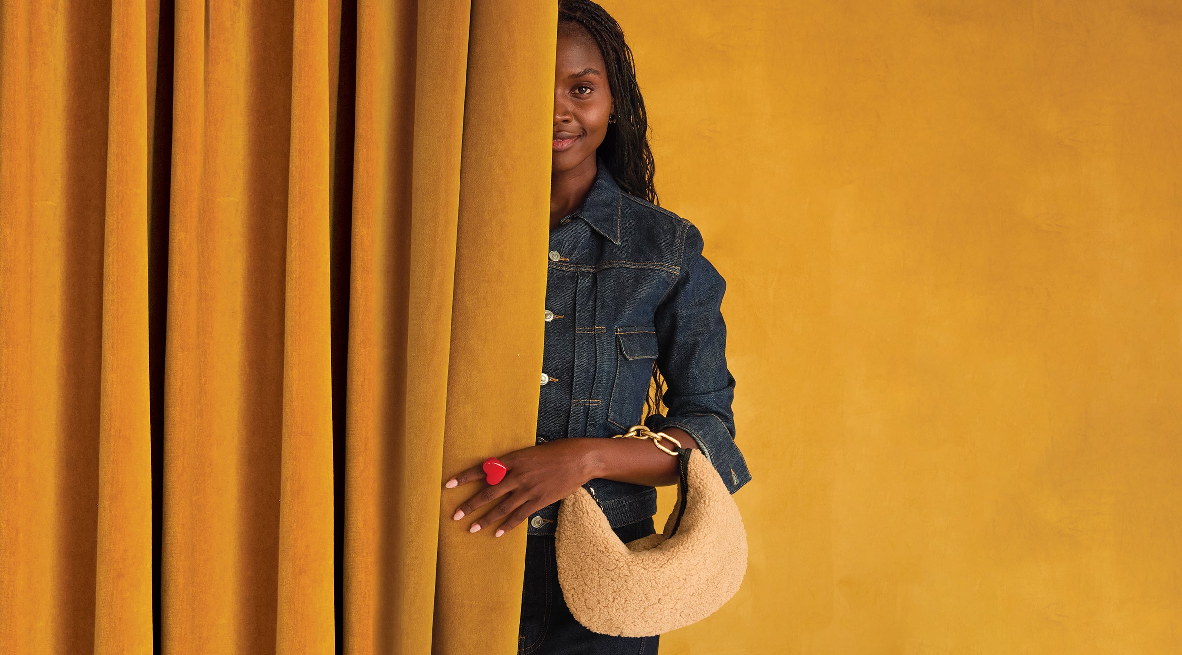 Model carrying the Shearling Lune with Vintage Gold Top Handle Bébé. 