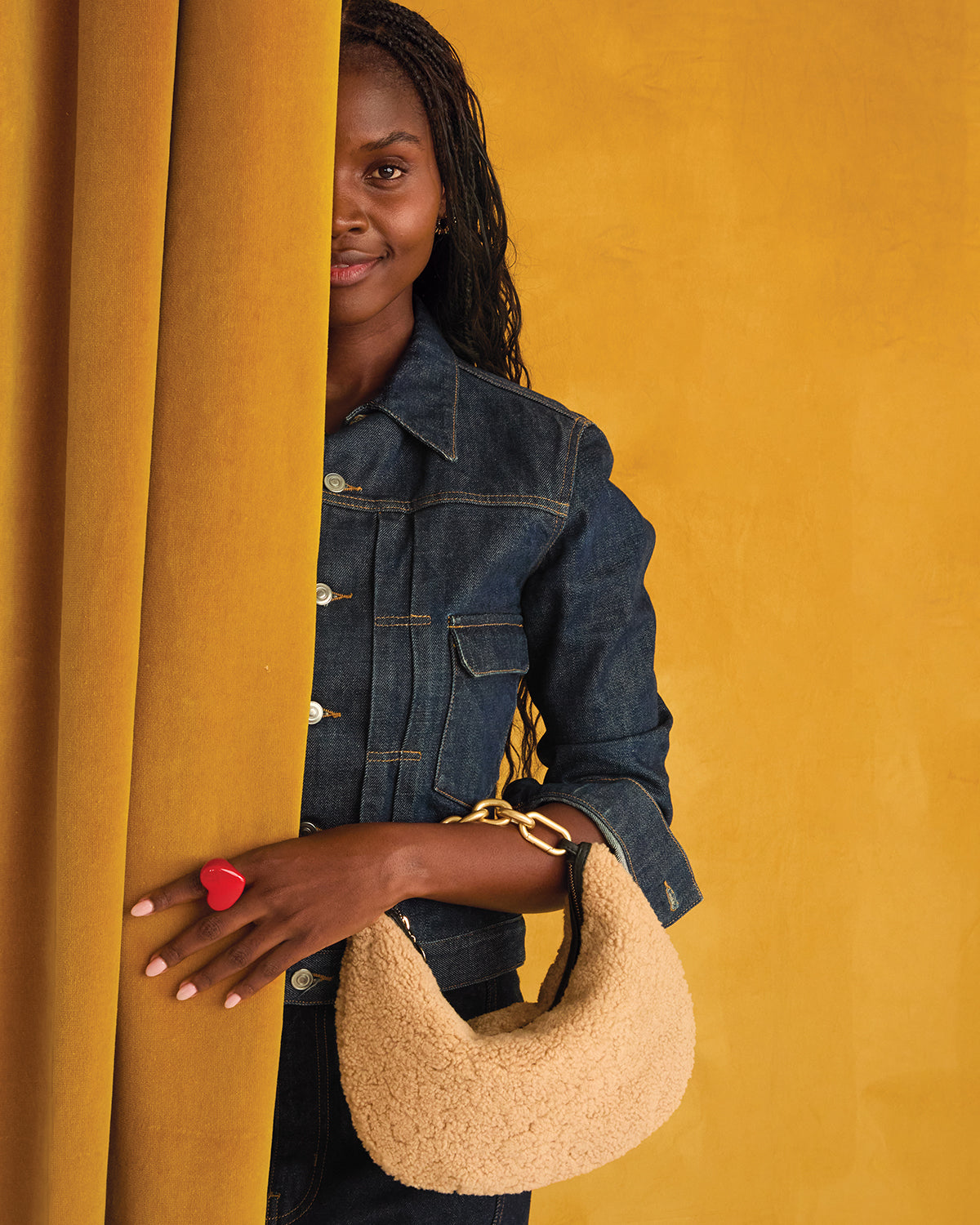Model carrying the Shearling Lune with Vintage Gold Top Handle Bébé. 