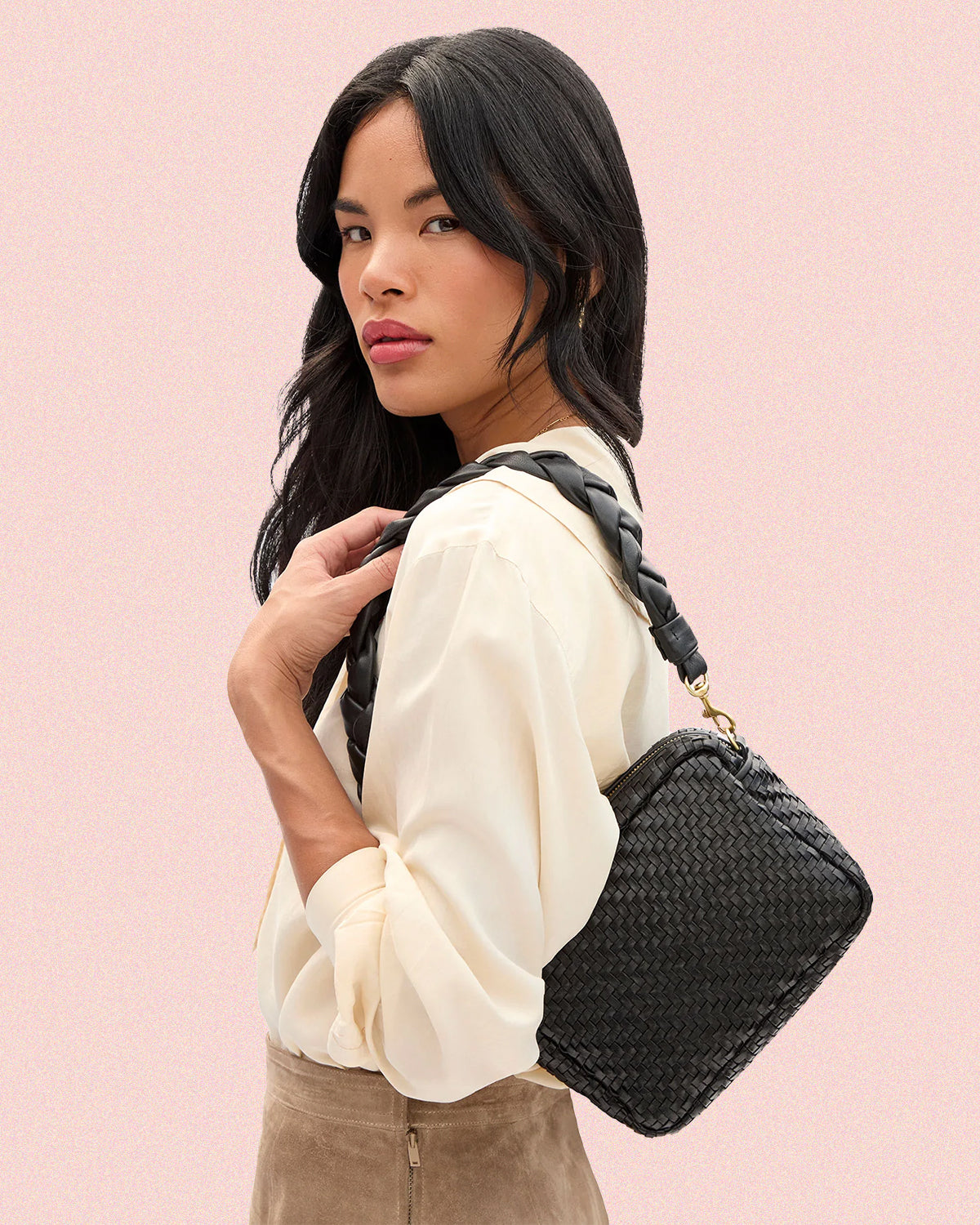 Model carrying the Black Woven Midi Sac with Black Braided Shoulder Strap.