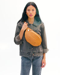 Model carrying the Tan Rattan Grande Fanny. 