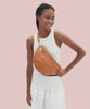 Model wearing the Natural Woven Grande Fanny as a crossbody bag and around her waist. 