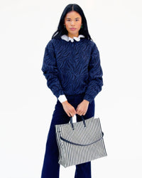 Model carrying the Black/Cream Woven Stripe Simple Tote.