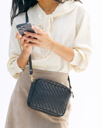 Model carrying the Black Woven Zig Zag Midi Sac.