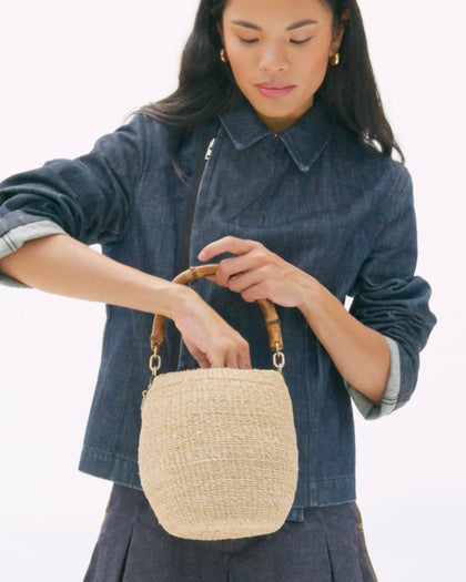 Model carrying the Cream Pot de Miel with Bamboo Handle.