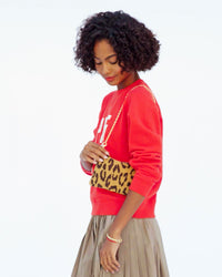 Vitoria grabs lipstick out of her Wallet Clutch w Tabs and applies a fresh coat