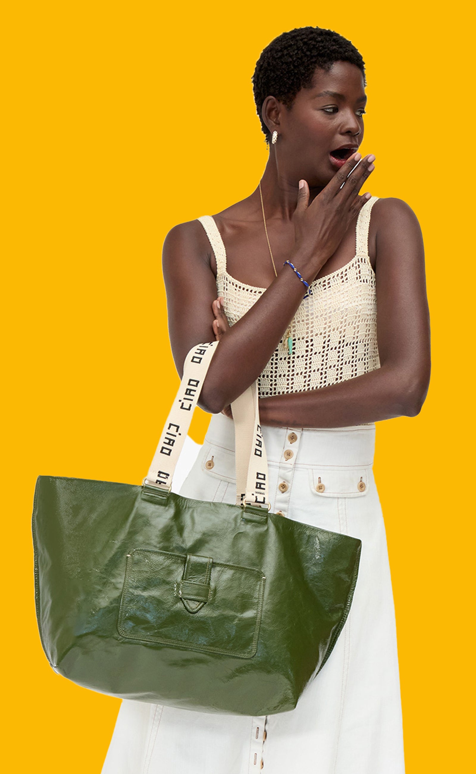Model carrying the Army Grand Bateau Tote with the shoulder straps on her forearm. 