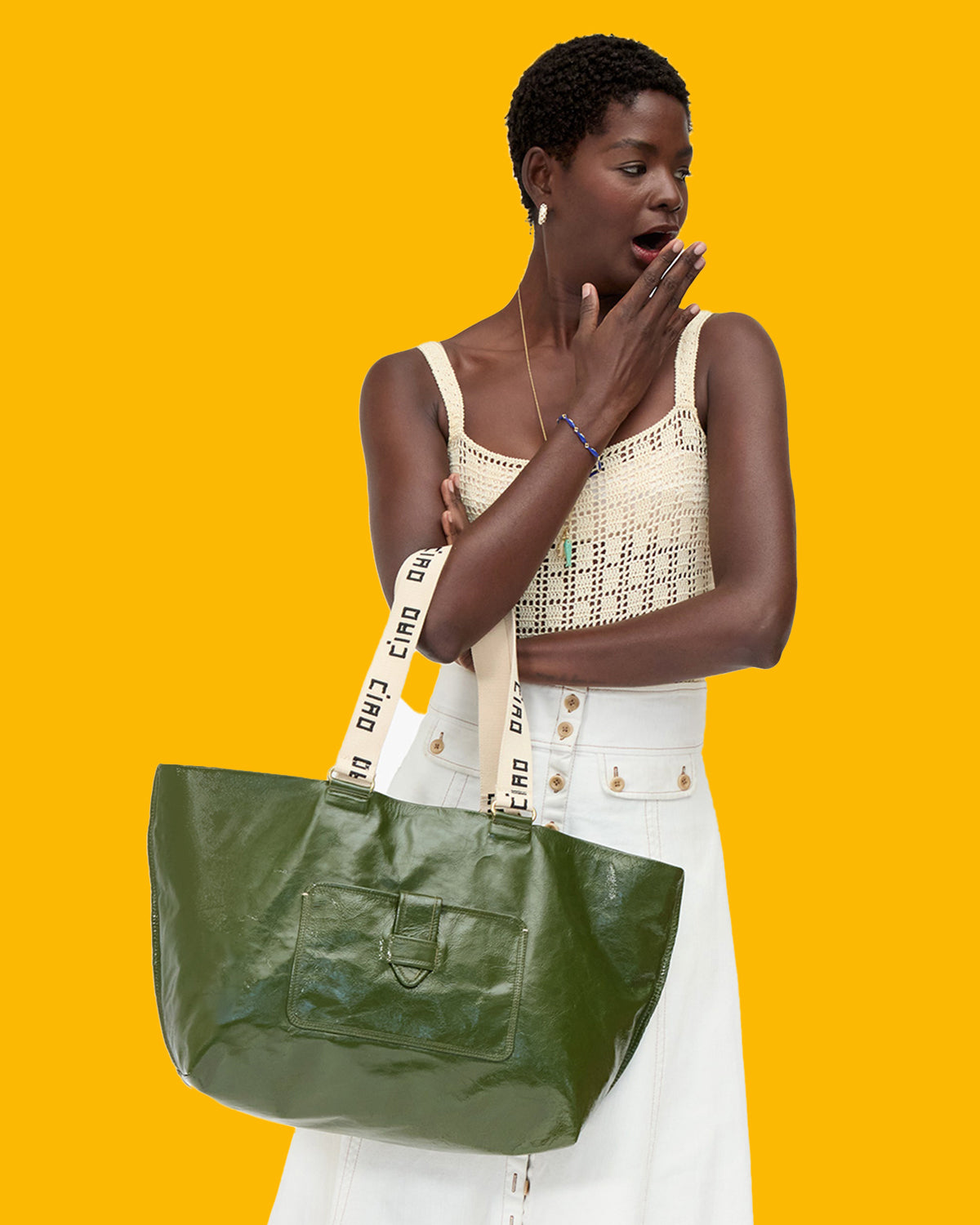 Model carrying the Army Grand Bateau Tote with the shoulder straps on her forearm. 