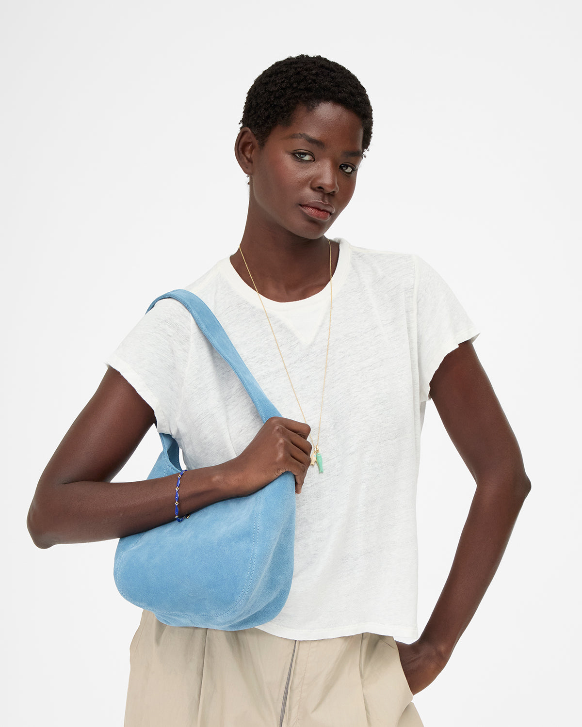 Model carrying the Desert Blue Petit Bando over her shoulder. 