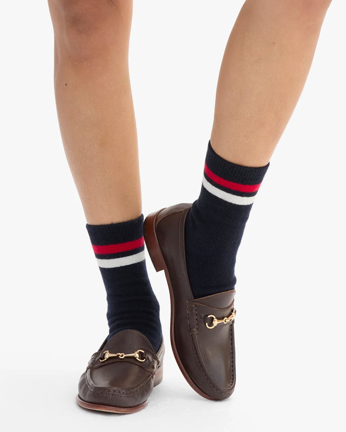 Model wearing Varsity Cashmere Crew Socks in Navy with brown loafers. 