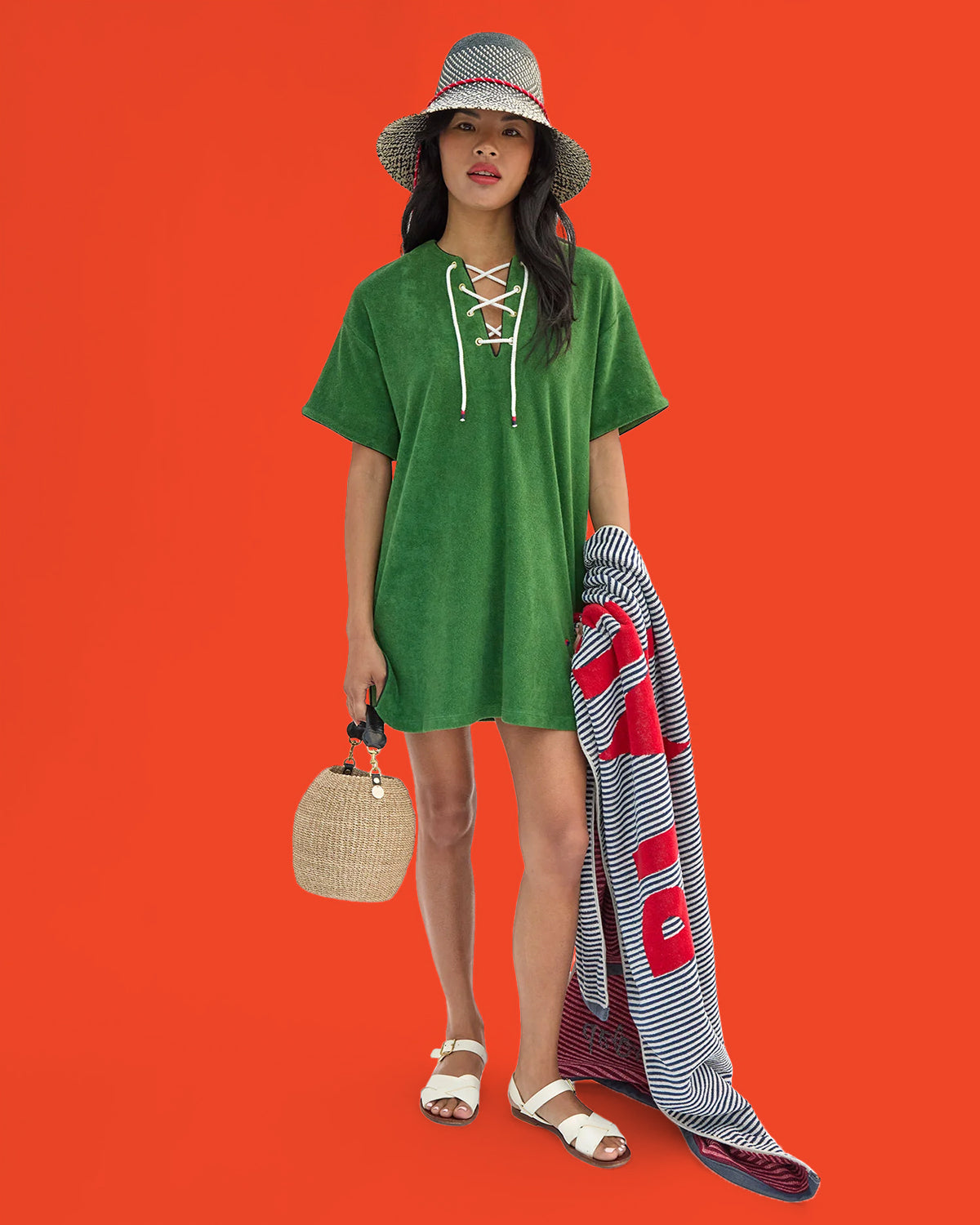 Model wearing the Basil La Plage Dress while carrying the Pot de Miel and holding Le Towel.