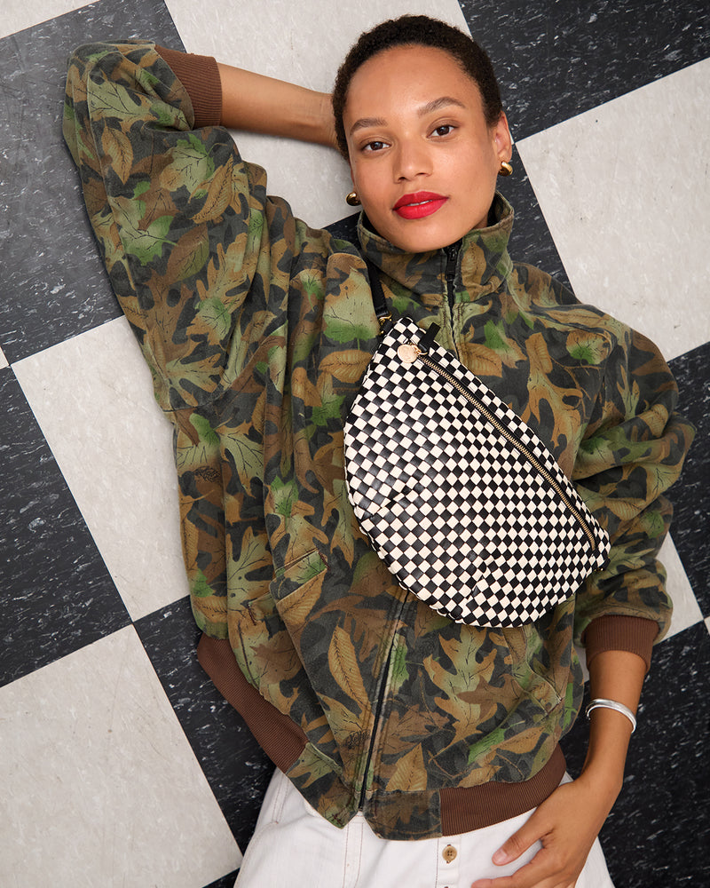 Model carrying the Black/Cream Woven Checker Grande Fanny.