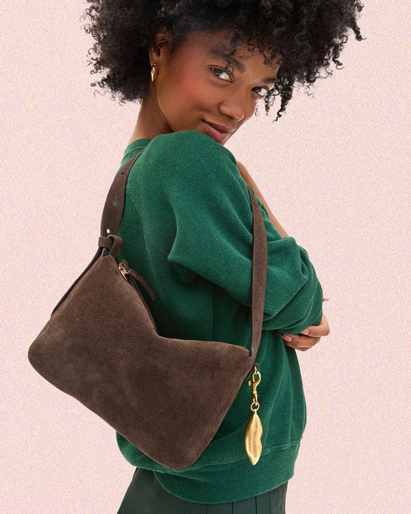 Model carrying the Chocolate Fleurine with Surrealisme Lips Fob.