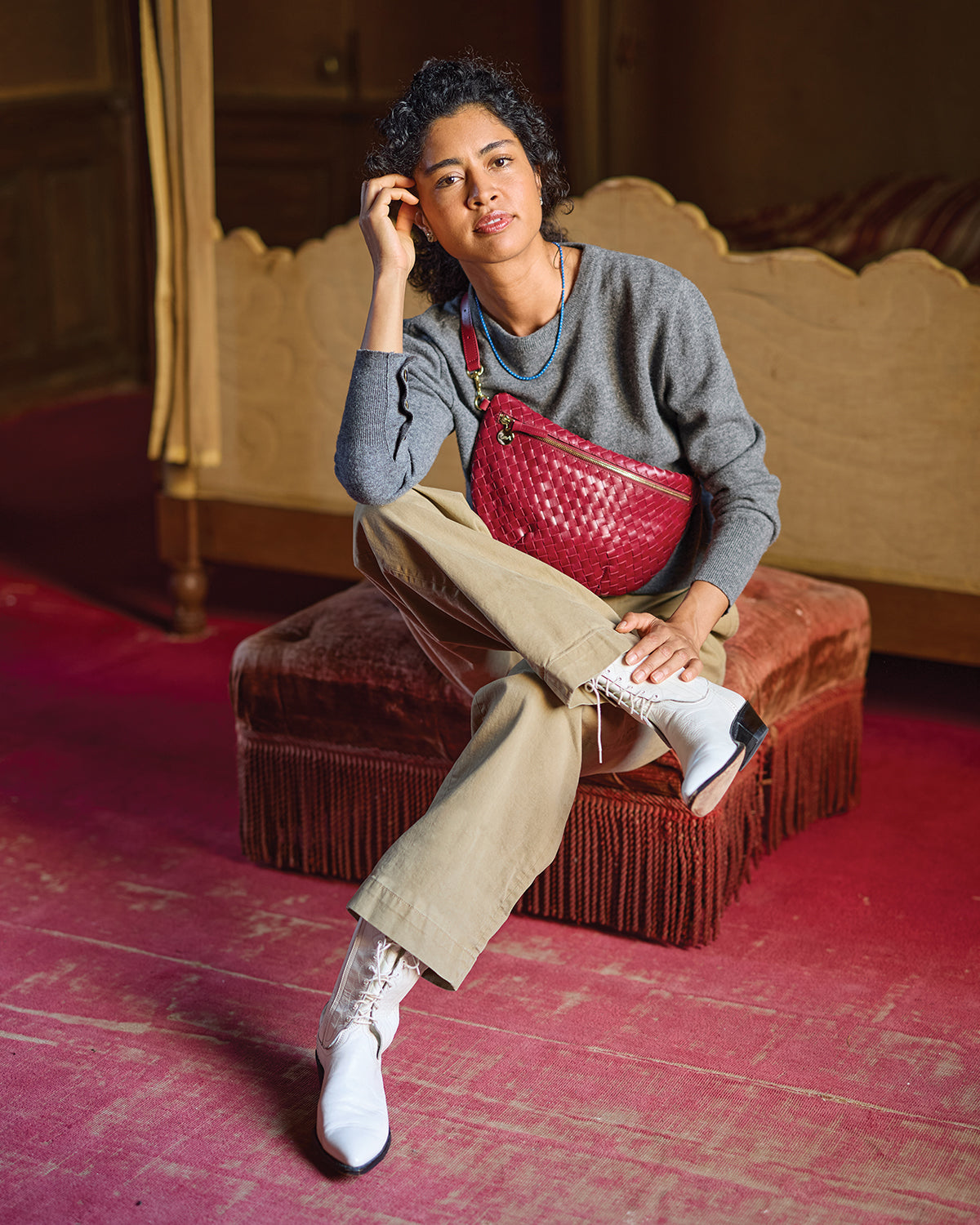 Model carrying the Garnet Diagonal Woven Grande Fanny across her chest. 