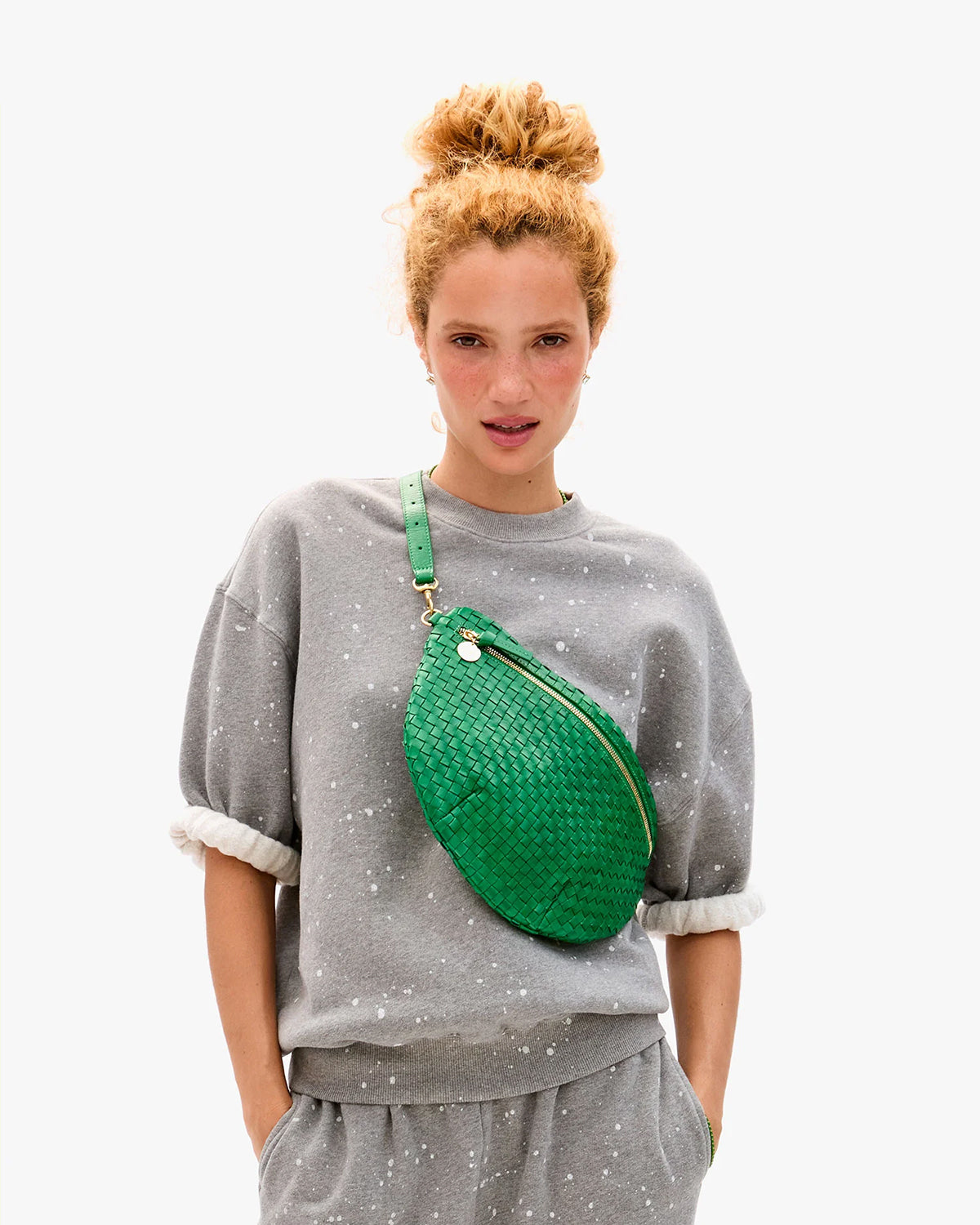 Model carying the Grass Woven Checker Grande Fanny across her chest.