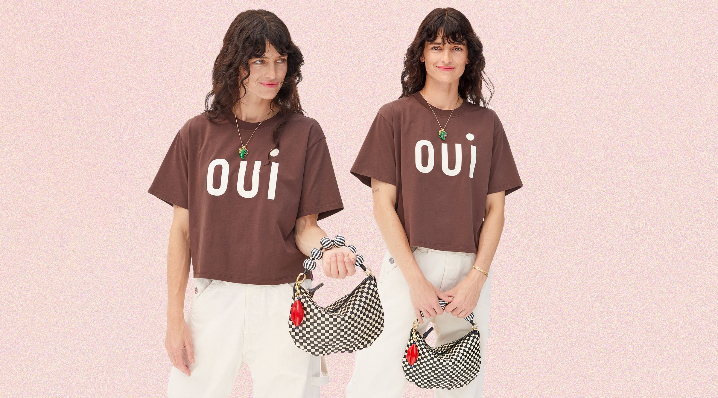 Model wearing the Oui Le Carré Tee and carrying the Petit Moyen in Black/Cream Woven with an additional Top Handle Strap and Lips Fob.