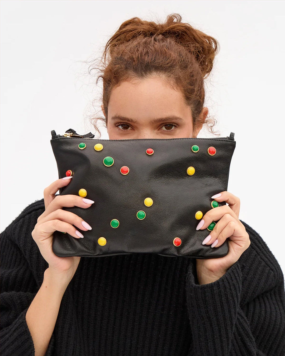 Model holding the Black with BonBon Studs Flat Clutch with Tabs. 