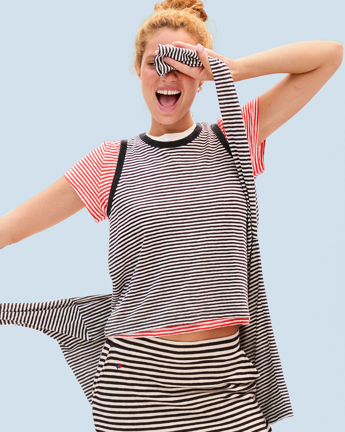 Model wearing our striped tank, classic tee, mini skirt, and long sleeve tee. 
