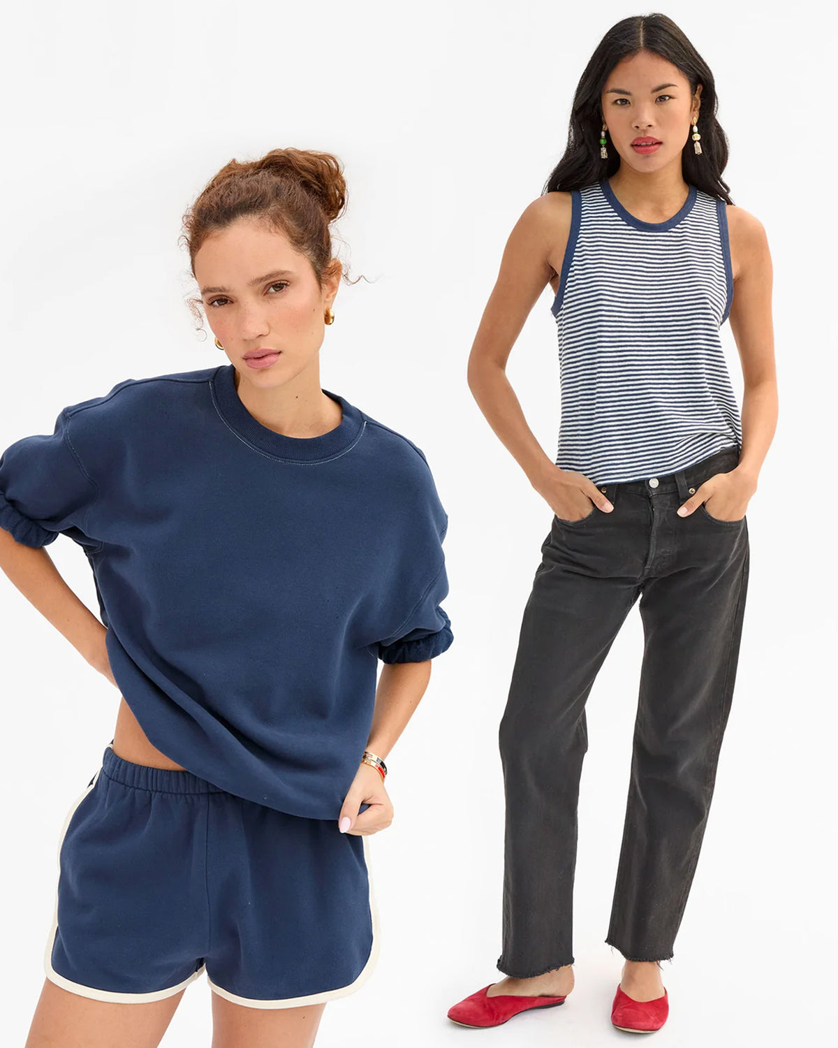 Models wearing the Navy Short Sleeve Oversized Sweatshirt with matching Le Jogging Shorts and another model wearing the Navy with Cream Camp Fit Tank with black jeans. 
