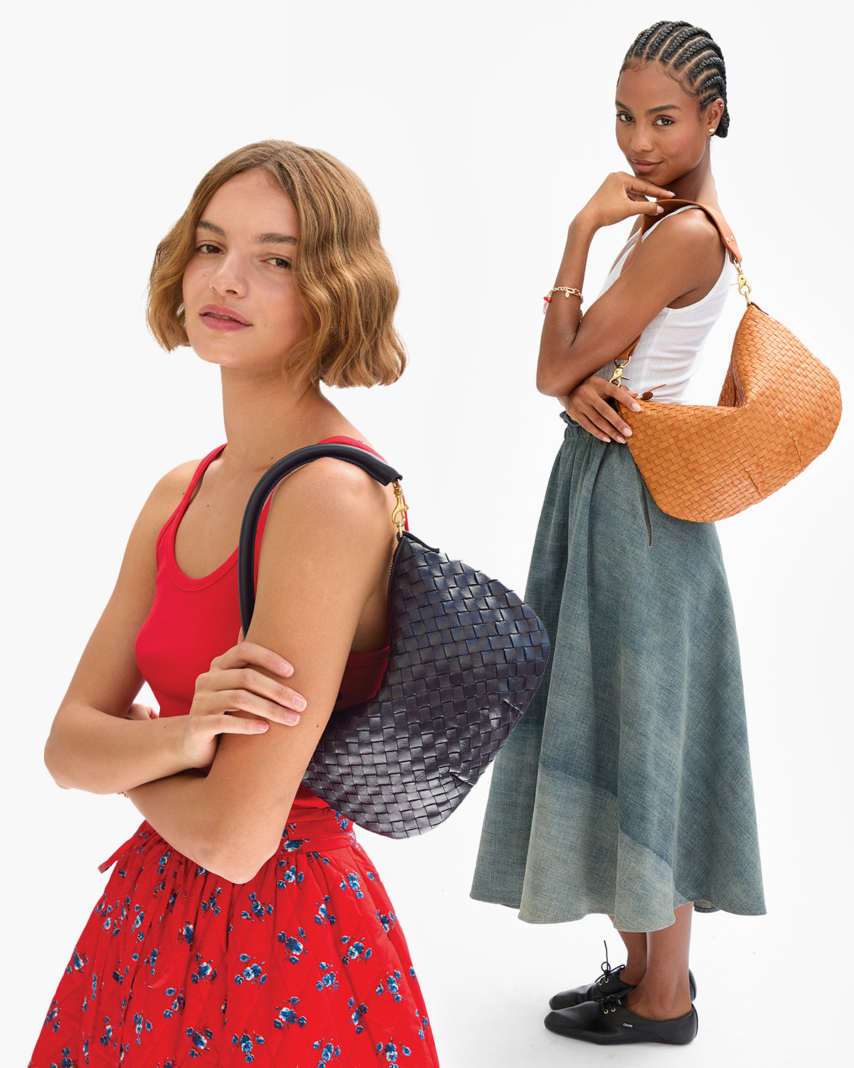 Two models carrying the Petit Moyen in Twilight and Moyen Messenger in Natural Woven Checker. 