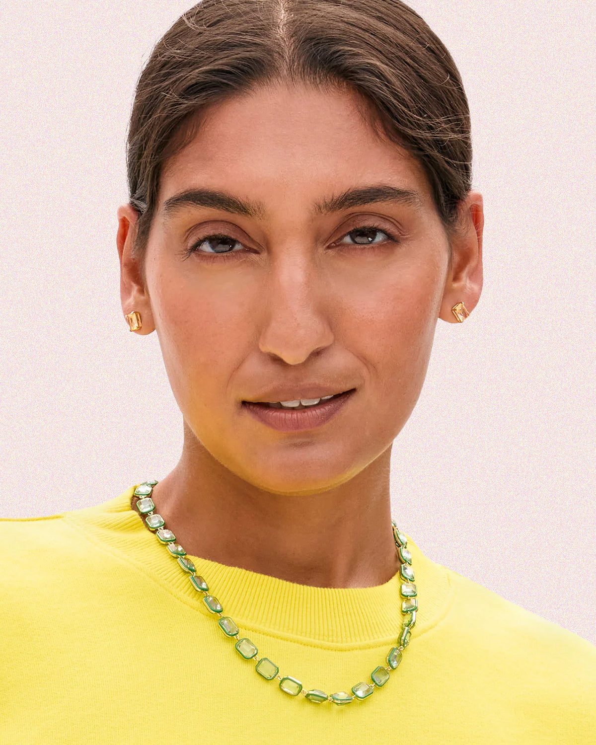 Model wearing a yellow sweatshirt with the Mint Bijoux Bead Necklace.