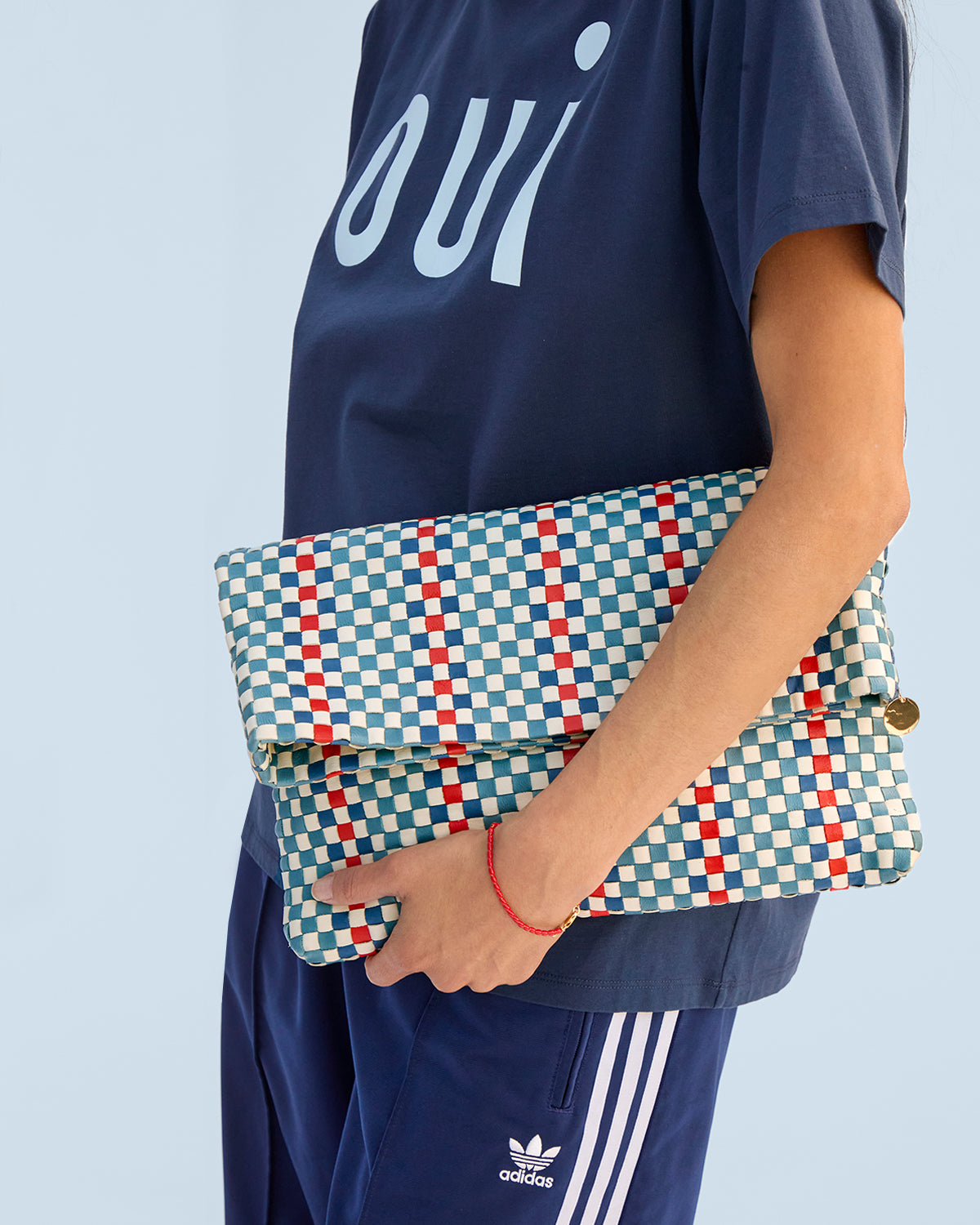 Desert Blue Multi Stripe Woven Checker
Carryall Clutch with Tabs carried as a foldover clutch. 
