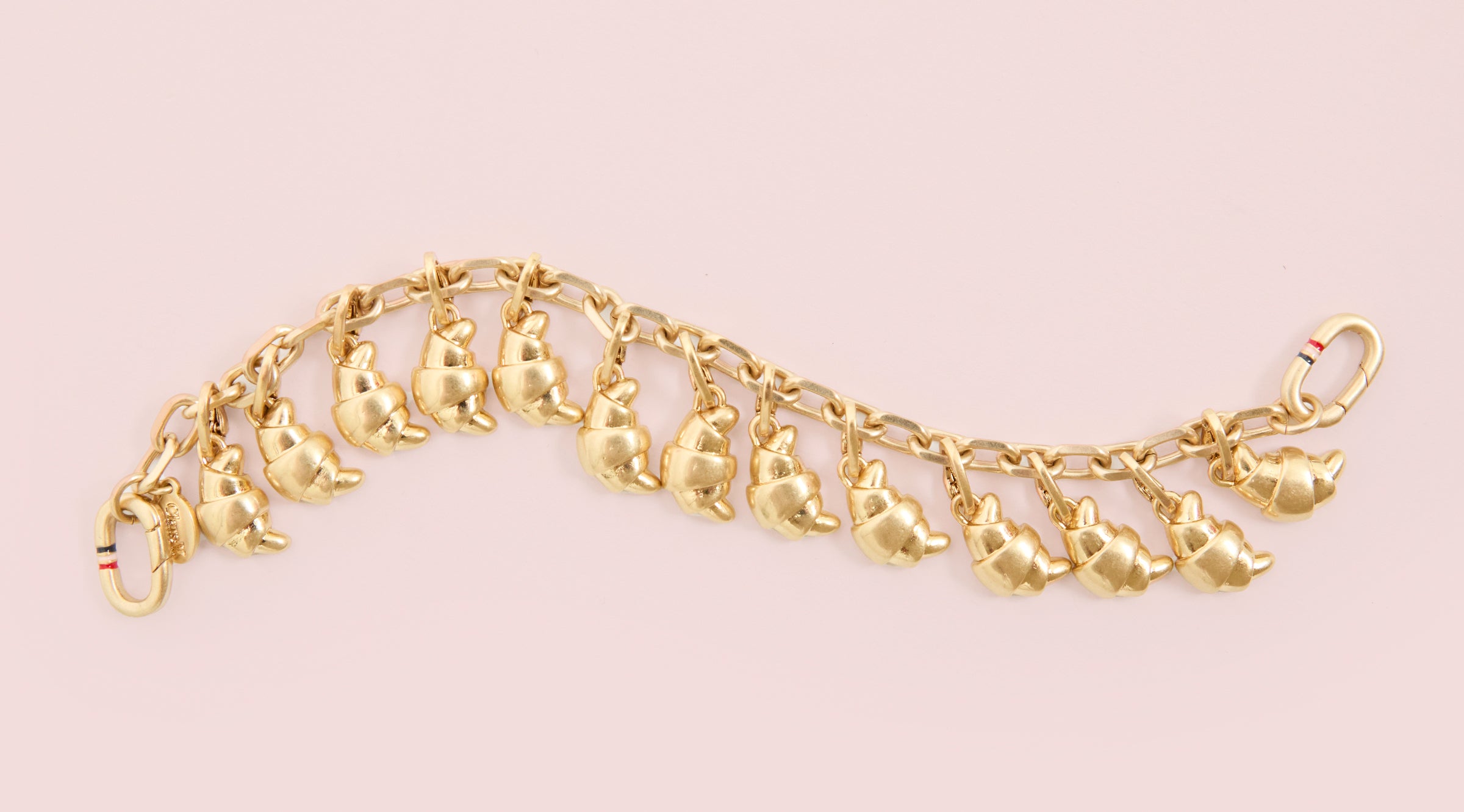 Charm Bracelet with 13 Croissant Charms attached to it. 