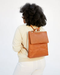 candice facing away from the camera wearing the cuoio perf Agnes Backpack