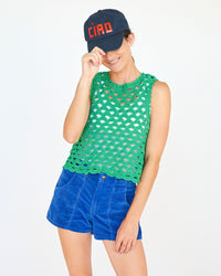 danica wearing shorts and a tank top with the Navy ciao Baseball Hat