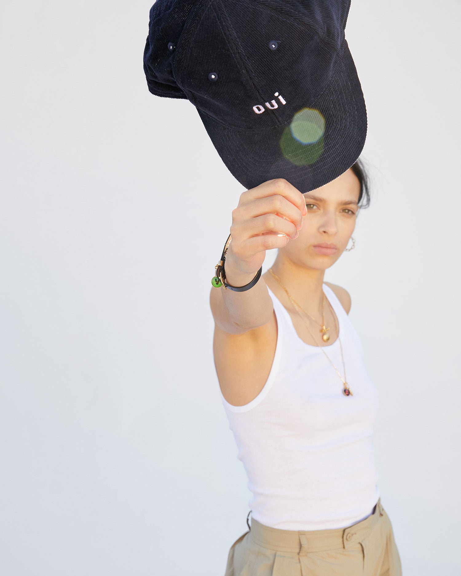 aurelia holding the Navy Corduroy Baseball Hat up to the sun