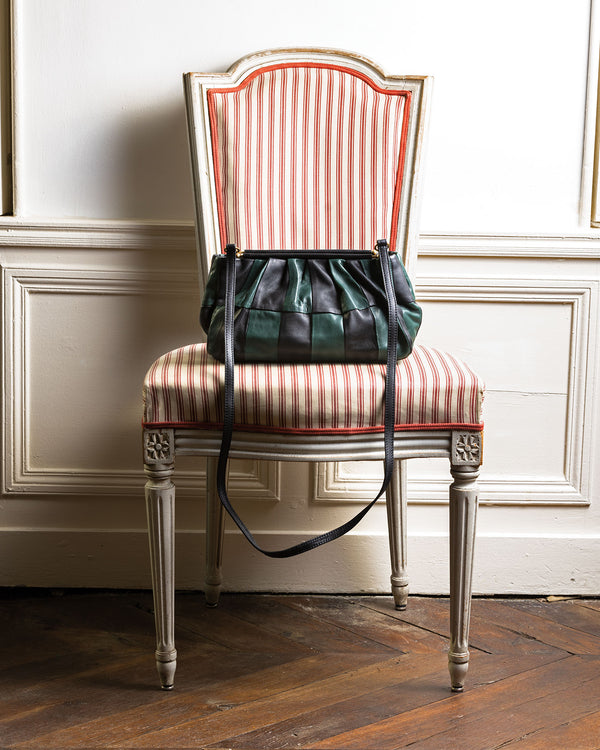 Black & Deep Sea Belle sitting on a chair. 