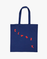 back image of the Navy Paris L.A. Canvas Store Tote. There is the cascading Clare V. logo in red