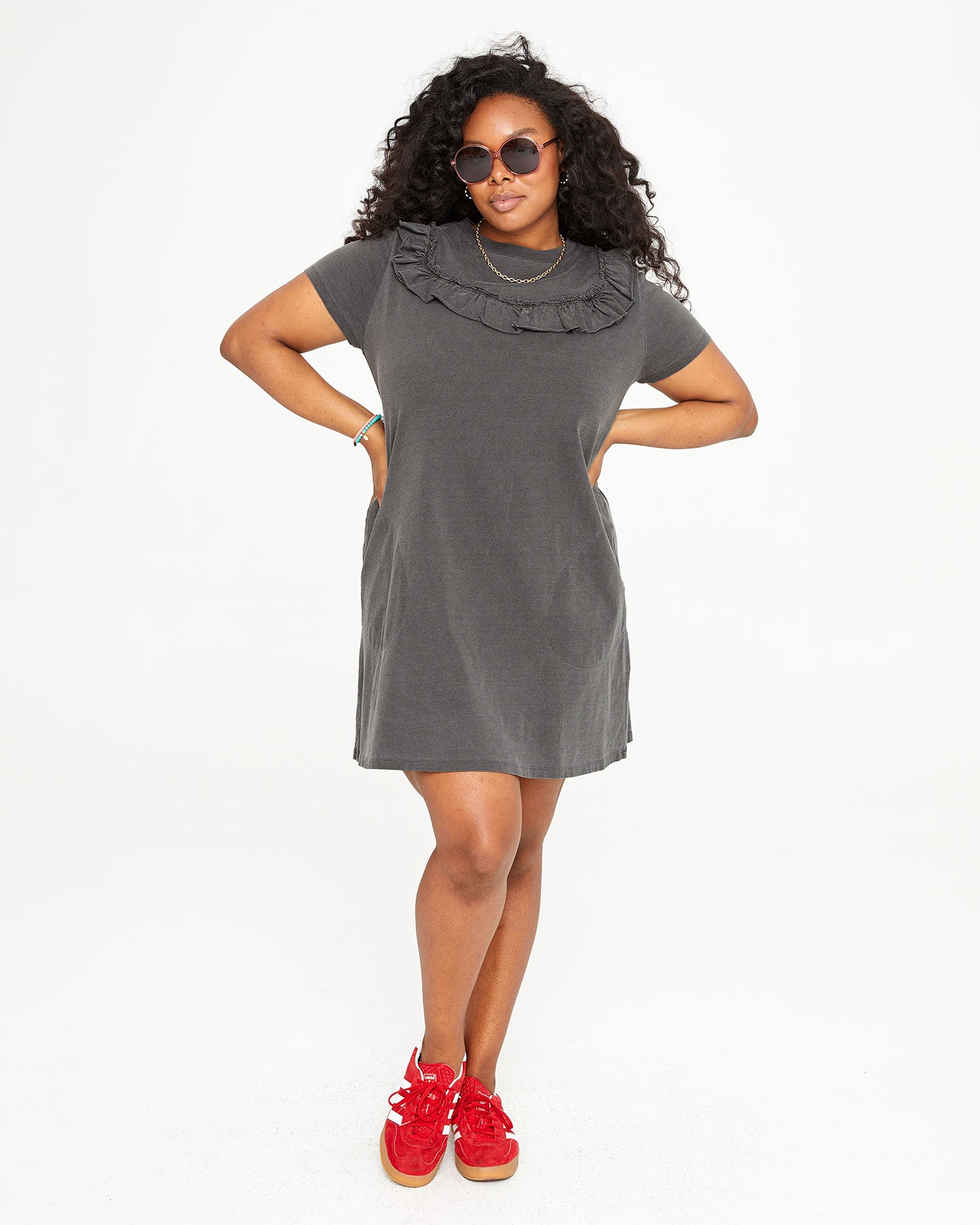 Candice wearing the Faded Black Charlotte Ruffle T-Shirt Dress with her hands on her hips