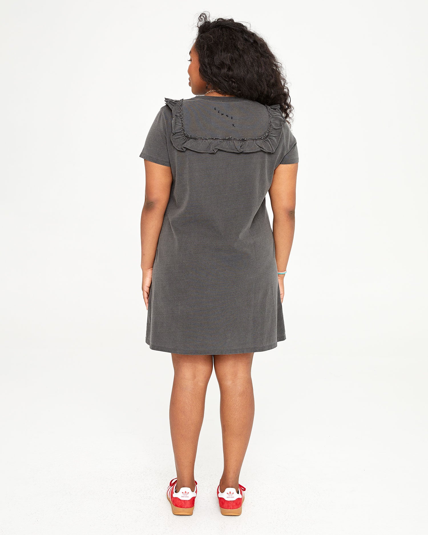 back view of candice in the Faded Black Charlotte Ruffle T-Shirt Dress