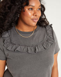 close up of the ruffles on the top portion of the Faded Black Charlotte Ruffle T-Shirt Dress worn by candice