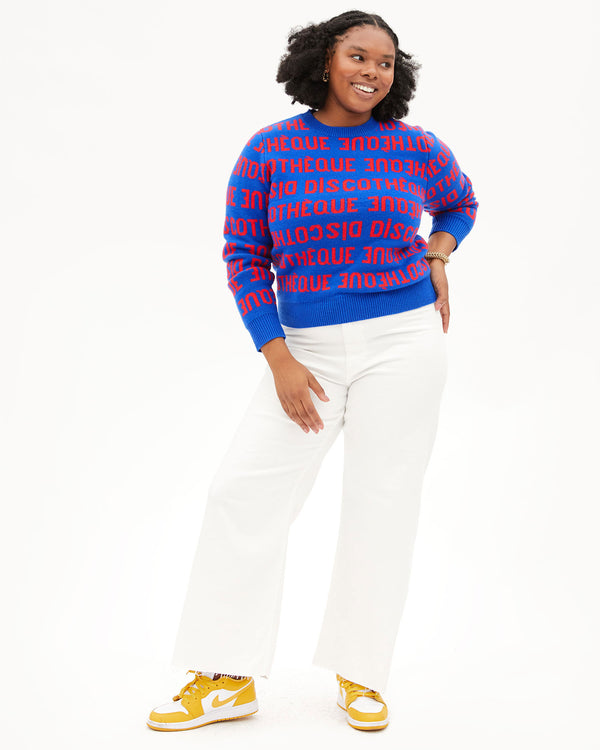 candace wearing the Cobalt & Poppy Discotheque Classic Sweater with white pants with white and yellow jordans