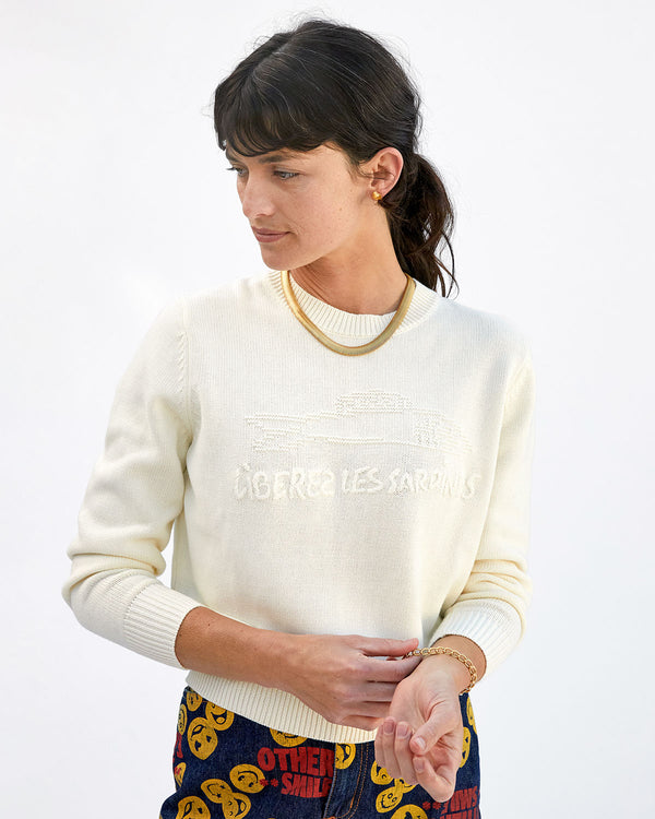 danica touching the bracelet on her wrist in the cream liberez les sardines Classic Sweater