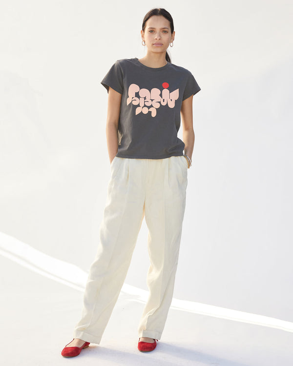 Aurelia is wearing the Faded Black Paris L.A. Classic Tee  with cream slacks and red flats