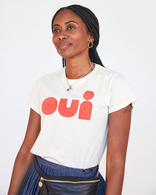 mecca looking off into the distance in the Cream with Poppy Oui Classic Tee