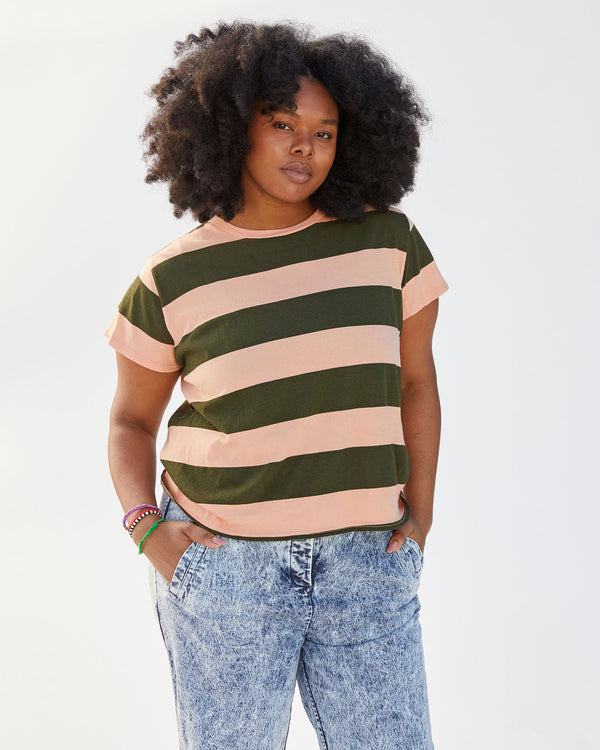 candice wearing the army and coral rugby stripe classic tee with her hands in her pockets