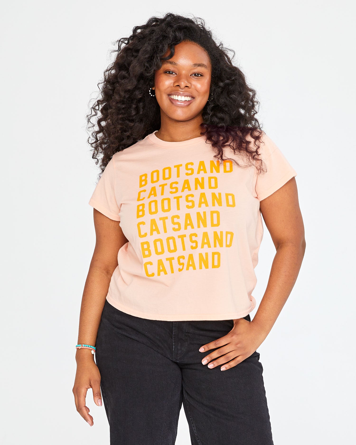 Candice wearing the Blush with Neon Orange Boots and Cats print Classic Tee with black jeans