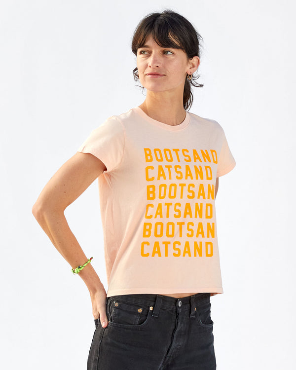 Danica wearing the Blush with Neon Orange Boots and Cats print Classic Tee with black jeans