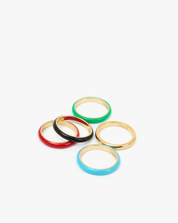 Poppy, Black, Emerald, Yellow Gold, and Turquoise Enamel Stacking Rings Sitting Close To Each Other