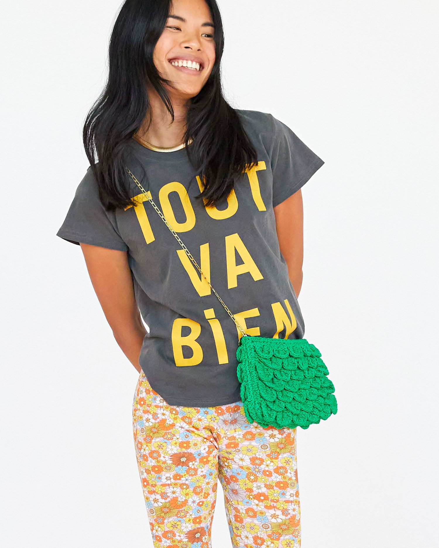 Sandra wearing the faded black with tout va bien classic tee with floral pants