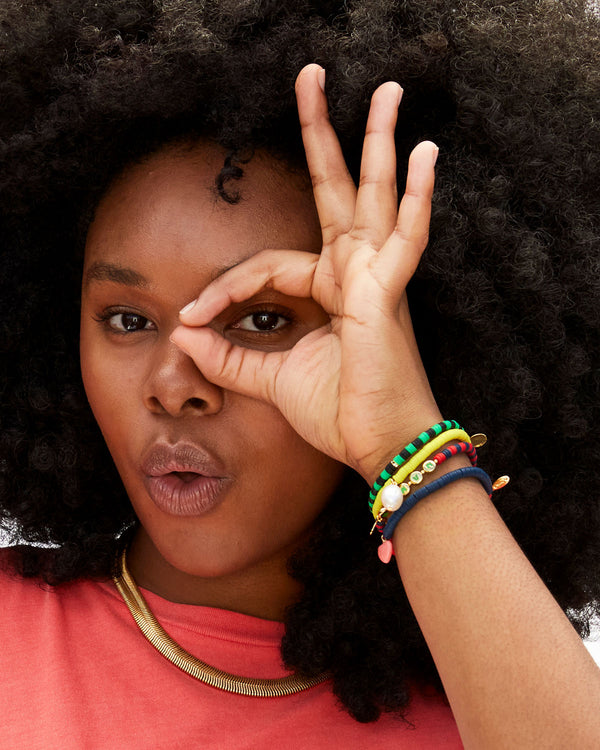 Candace Doing an Okay Sign On Her Eye with Her Right Hand And Wearing Four of Our Beaded Bracelets Stacked On Her Wrist