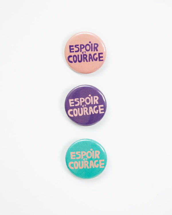 Close up of the Pins included with the Clare V. x Gabrielle Giffords Canvas Tote printed with Espoir et Courage