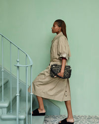 Bree Carrying Our Army Pablo Cat Suede Gosee Clutch with Our Black Braided Shoulder Strap Attached To It