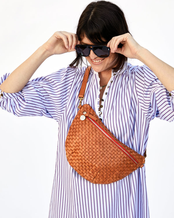 Danica Pushing up her Sunglasses in a Blue & White Striped Dress with the Natural Woven Checker Grande Fanny Worn Across her Chest