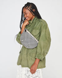 mecca wearing an army green jacket and a white lace skirt with the Black & Cream Checker Grande Fanny worn across her chest