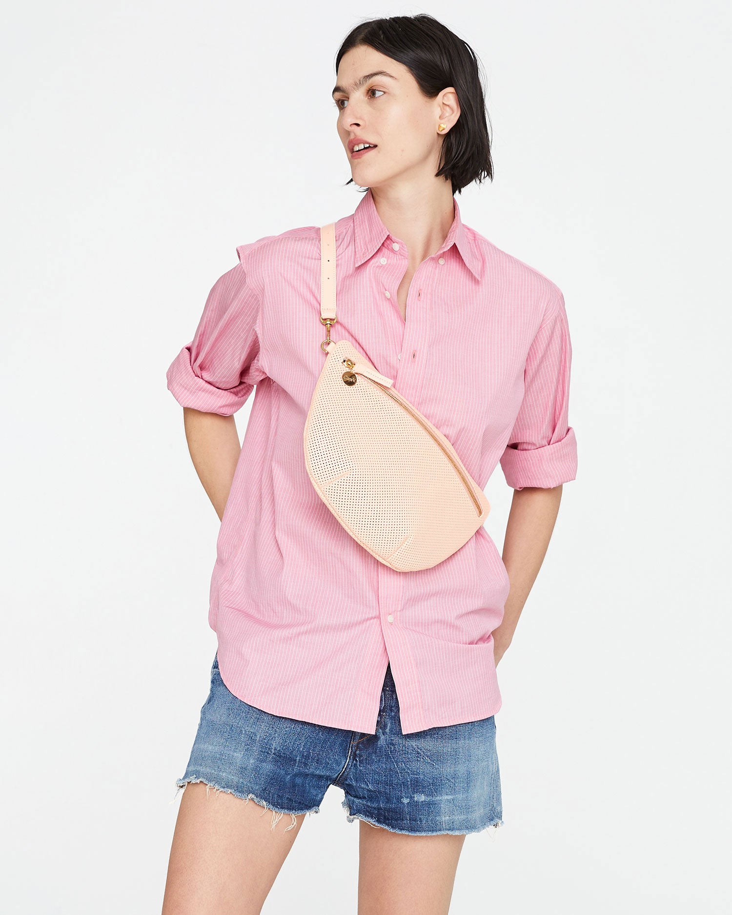 athena wearing the Ballet Perf Grande Fanny across her chest. she's wearing denim shorts and a long sleeve button up